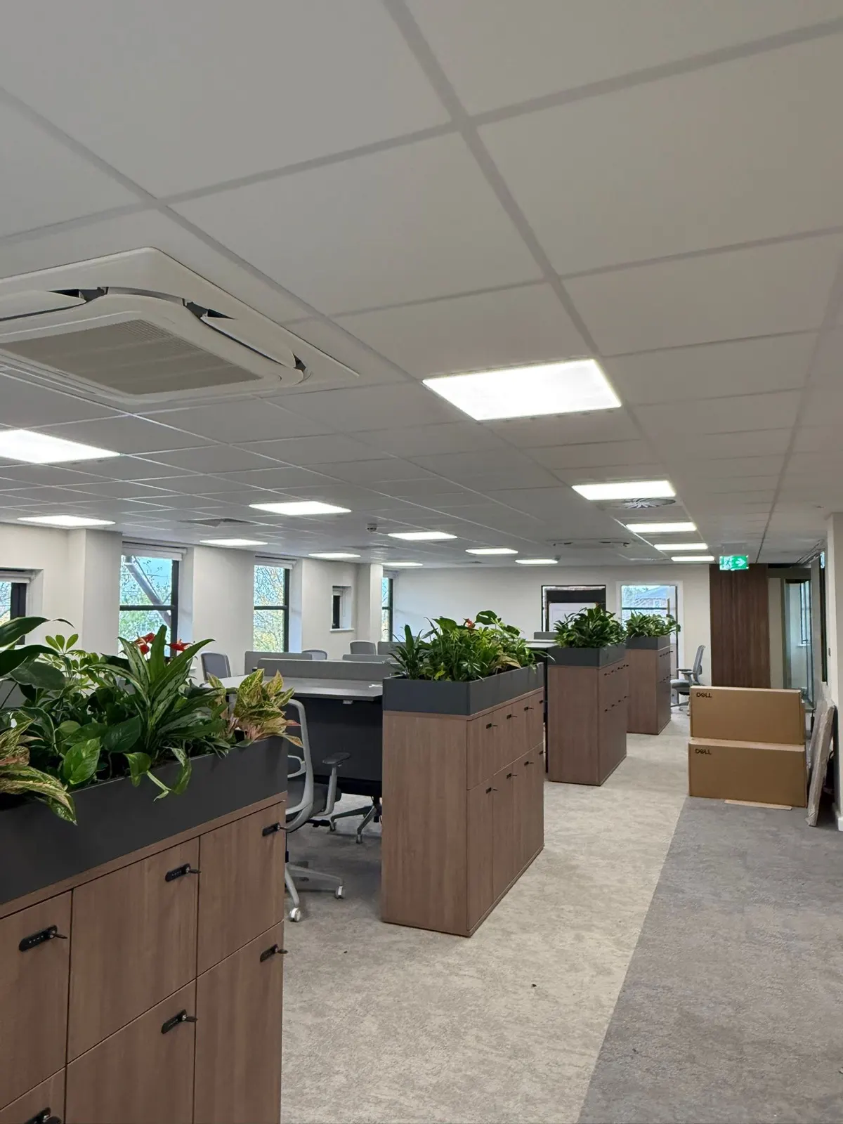 Ceiling cassette air conditioning unit in a finished open-plan office